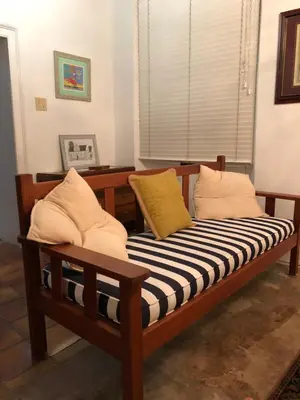 a wooden bench with pillows on it in a room at Becketts Bliss in Worcester