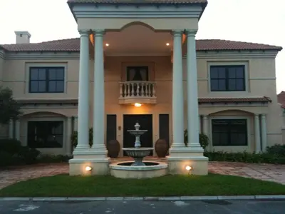 a large house with a fountain in front of it at Roman Retreat in Cape Town