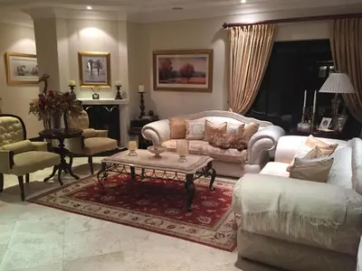a living room with a couch and a table at Roman Retreat in Cape Town