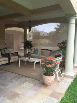 a patio with a couch and a coffee table at Roman Retreat in Cape Town
