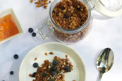 a plate of granola and a jar of jam at StayEasy Century City in Cape Town