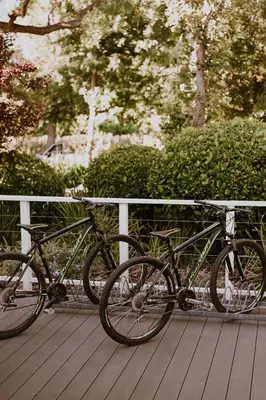 two bikes parked next to a fence on a deck at Vrede en Lust Estate in Simondium