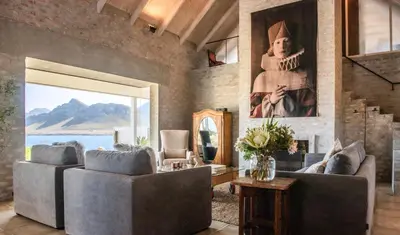 a living room with two couches and a painting at Pringle Bay Home in Pringle Bay