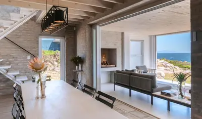 a living room with a table and a couch at Pringle Bay Home in Pringle Bay