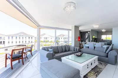 a living room with a couch and a table at Lagoon Beach 237A by CTHA in Cape Town