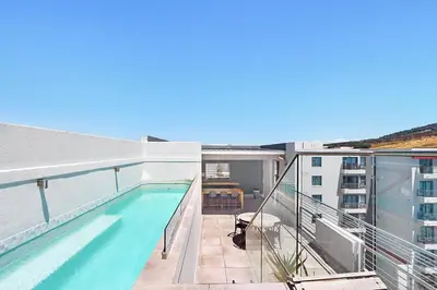 a balcony with a swimming pool on a building at The Paragon 317 in Cape Town