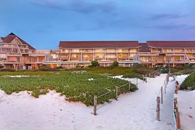 a resort on the beach with a pathway to the beach at Dolphin Beach E5 in Bloubergstrand