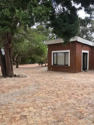 a small brick building with a window on a brick road at The Vineyard View in Joostenberg Vlakte