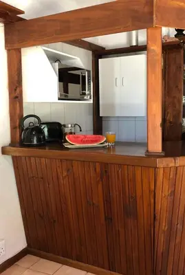 a kitchen with a wooden counter top with a microwave at The Vineyard View in Joostenberg Vlakte