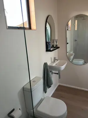 a bathroom with a toilet and a sink at Riverbend Farm in Robertson