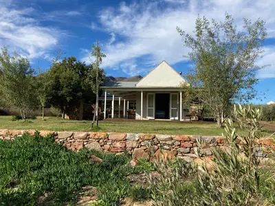 a house with a stone wall at Riverbend Farm in Robertson