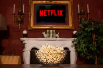 a bowl of popcorn sitting on a table with a tv at Ridgeworth Cottage in Greyton