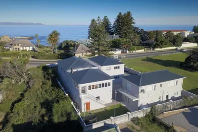 an aerial view of a house with the ocean in the background at 269 on Main Holiday Home in Hermanus