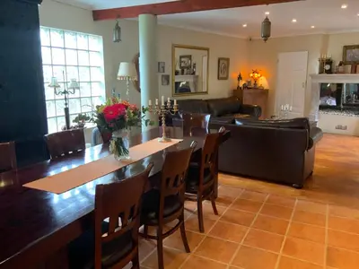 a living room with a table and a couch at Goblin's Mead in Edgemead