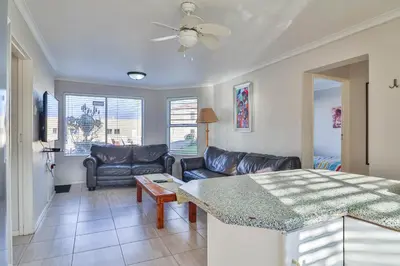 a living room with a couch and a table at 155 hbc in Hermanus