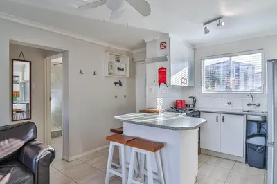 a kitchen with white cabinets and a counter top at 155 hbc in Hermanus