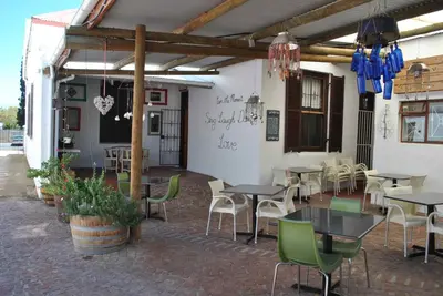 a patio with tables and chairs in a restaurant at Worcester Gallery Cottage in Worcester
