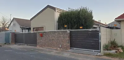 a fence in front of a house at Dawn's Place in Strand