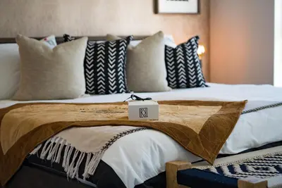 a large bed with a sign on top of it at Rainbow Residence in Franschhoek