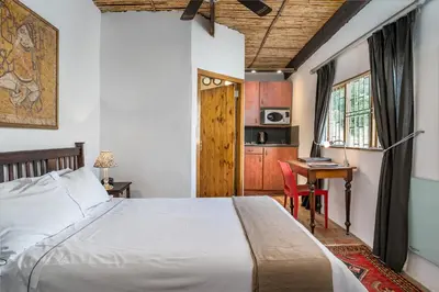 a bedroom with a bed and a desk at Oude Wellington Estate in Wellington