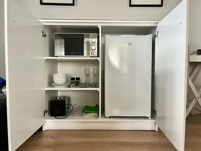 a kitchen with a refrigerator and a microwave at Oakvale Lodge in Cape Town