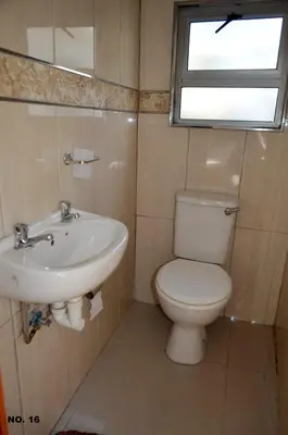 a bathroom with a toilet and a sink and a window at ST@Y-1-BnB in Cape Town