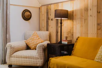 a living room with two chairs and a lamp at Southern Yurts in Botrivier