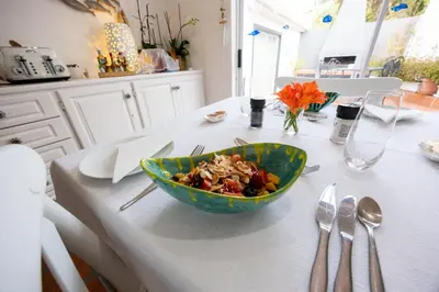 a table with a bowl of food on a table at Cosimi Guest House in Durbanville