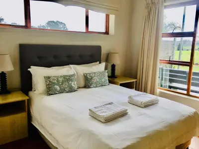 a bedroom with a large bed with two towels on it at Witzenberg Guest Farm in Wolseley