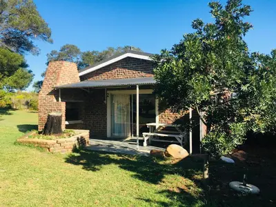 a brick house with a porch and a tree at Witzenberg Guest Farm in Wolseley