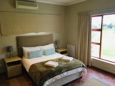 a bedroom with a bed with two towels on it at Witzenberg Guest Farm in Wolseley