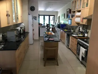 a large kitchen with a counter in the middle at At 27 on Derby in Cape Town