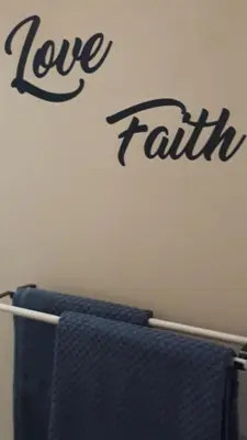 a wall with the words love faith written on it at Jack's Seaview in Bettyʼs Bay