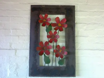 a picture of flowers in a frame on a wall at Jack's Seaview in Bettyʼs Bay