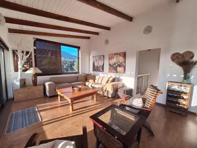 a living room with a couch and a table at Arbeidsgenot Beach House in Hermanus