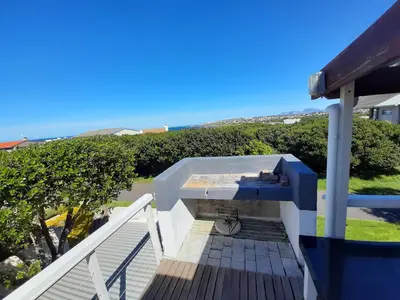 a balcony with a view of the ocean at Arbeidsgenot Beach House in Hermanus