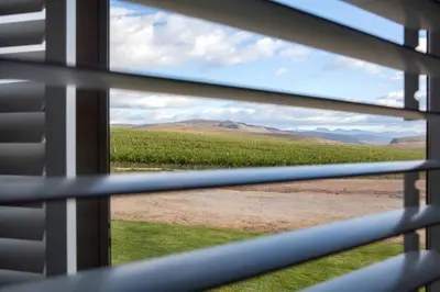 a view from a window of a field of crops at Lord's Wine Farm in McGregor