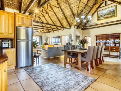 a kitchen and dining room with a table and chairs at Lord's Wine Farm in McGregor