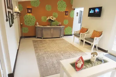 a living room with a couch and a table at The Potting Shed Guest House in Hermanus