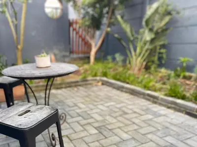 a table and two chairs sitting on a patio at Milnerton Cottage in Cape Town