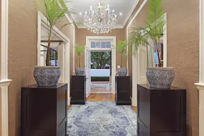 a hallway with two large vases on pedestals at Stellenbosch Manor in Stellenbosch
