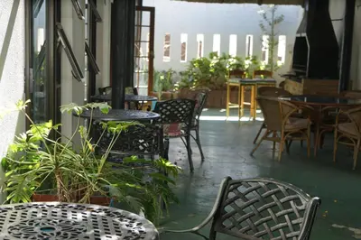 a patio with chairs and tables and tables and chairs at Peak Village Lodge in Bloubergstrand