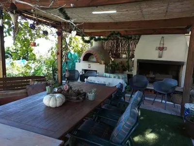 a living room with a wooden table and a fireplace at Ville la'Rina in Cape Town