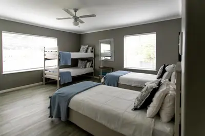 a bedroom with two beds and a ceiling fan at Son & Saffier in Hermanus
