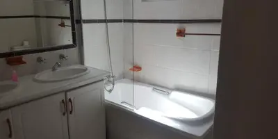a bathroom with a sink and a bath tub at Lodge Strand (The) in Strand