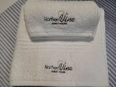two towels sitting on top of a white towel at Northern Vine Guesthouse B&B Self-catering in Brackenfell