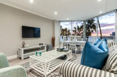 a living room with a couch and a table at Ashley on Beach Strand in Strand