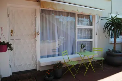 a window with a table and chairs in front of it at Brookshill - Protea suite in Somerset West