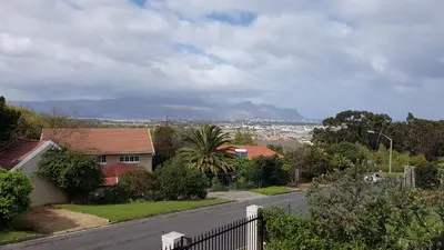 a view of a street with a house and a mountain at Brookshill - Protea suite in Somerset West