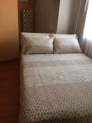 a bed with two pillows on it in a bedroom at Onyx on Sycamore in Cape Town